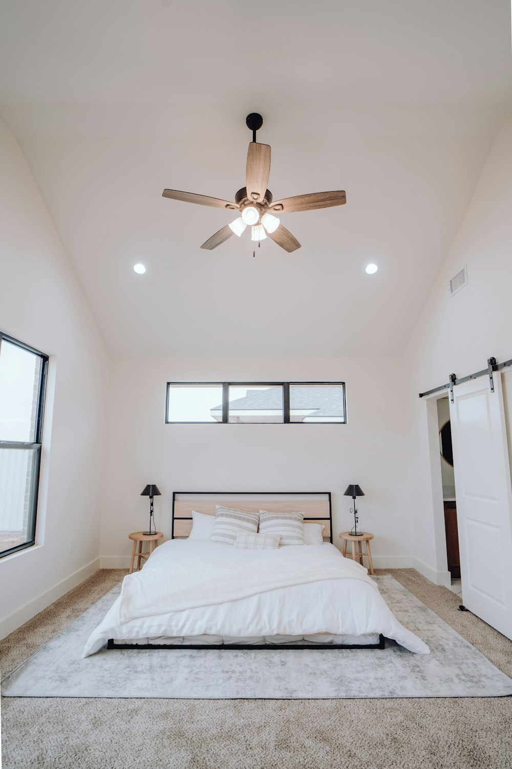 a bedroom with a bed and a ceiling fan