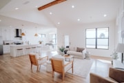 a living room filled with furniture and a kitchen