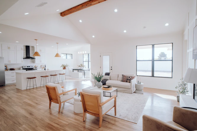 a living room filled with furniture and a kitchen