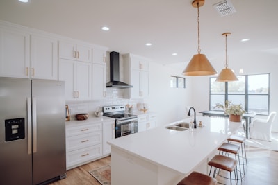 A bright, modern kitchen with stainless steel appliances and a large island bathed in natural light.