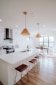 a large kitchen with a center island and bar stools