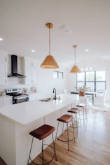 a large kitchen with a center island and bar stools