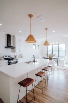 a large kitchen with a center island and bar stools