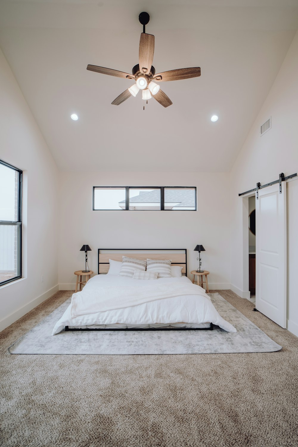 a bedroom with a bed and a ceiling fan