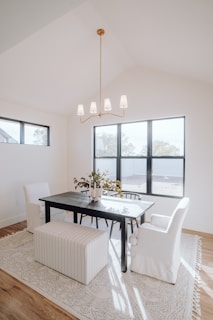 a dining room with a table, chairs, and a bench