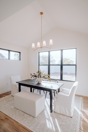 a dining room with a table, chairs, and a bench
