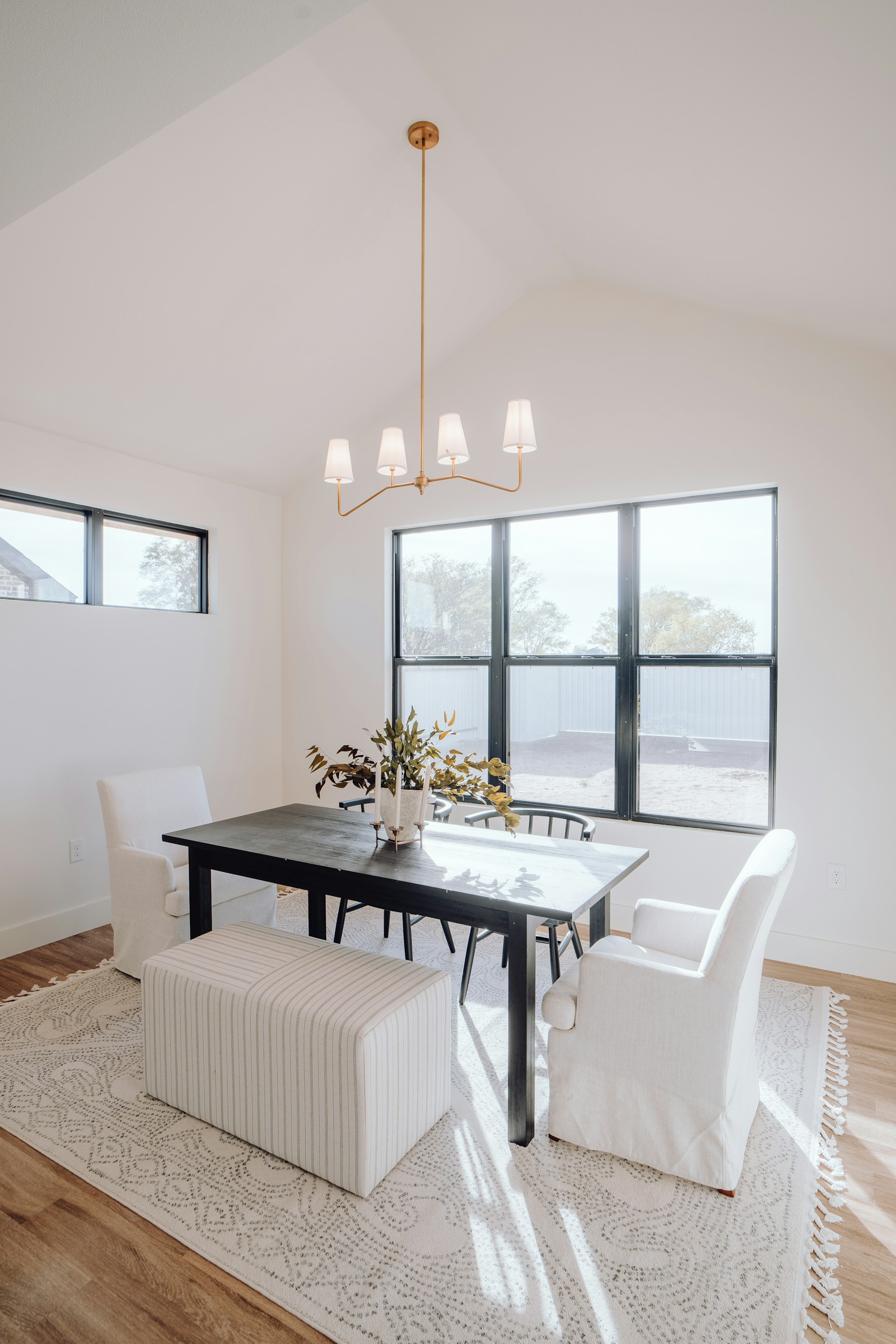 a dining room with a table, chairs, and a bench