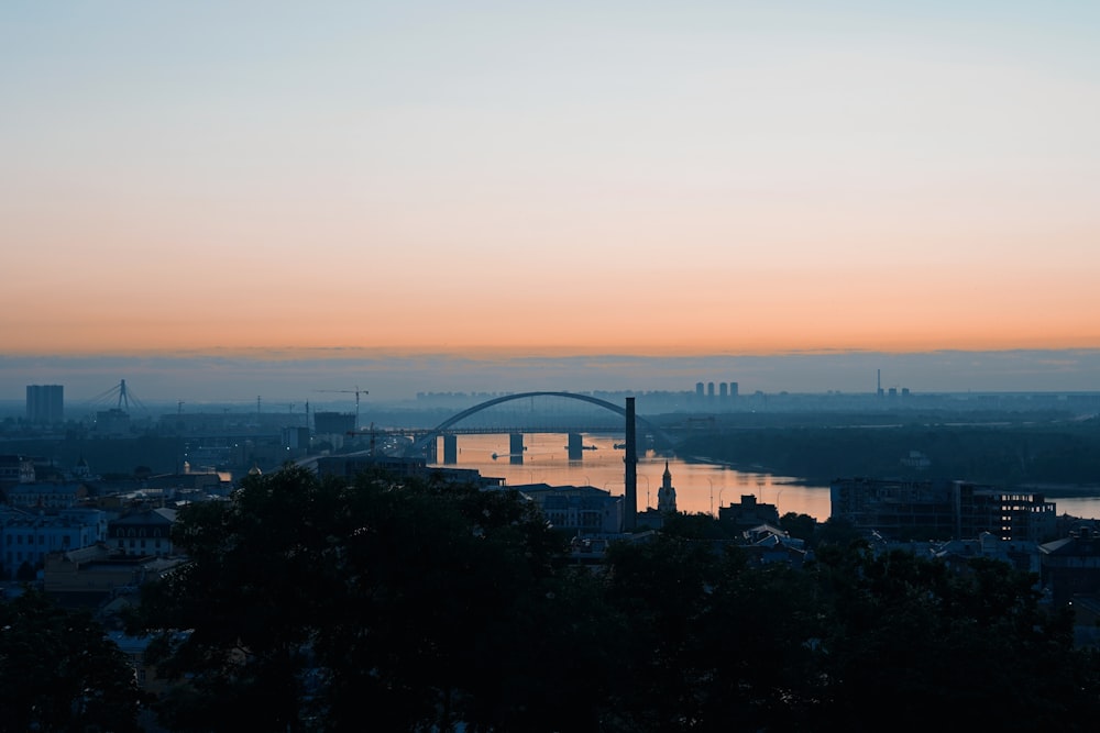 a view of a bridge over a river at sunset