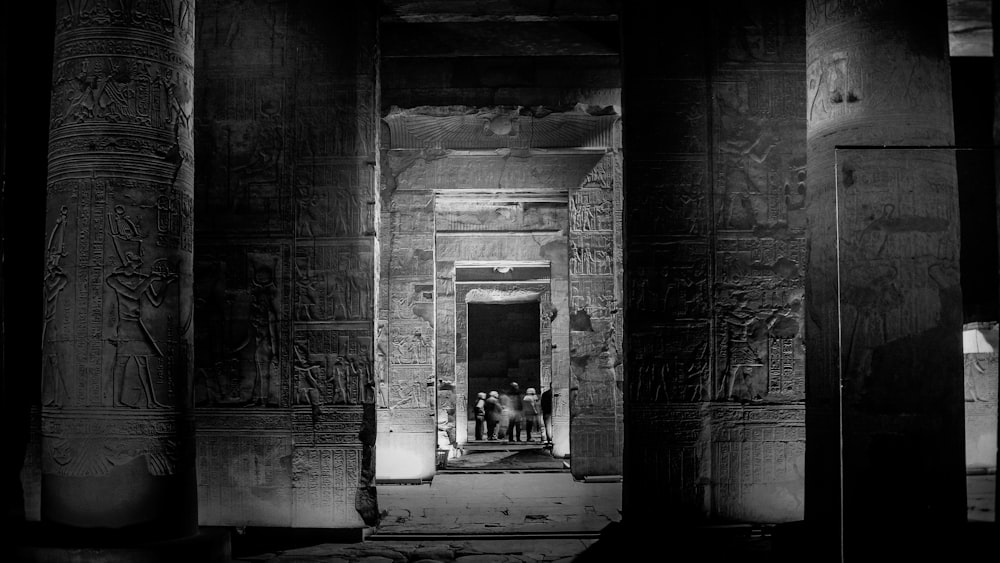 a black and white photo of some people in a doorway