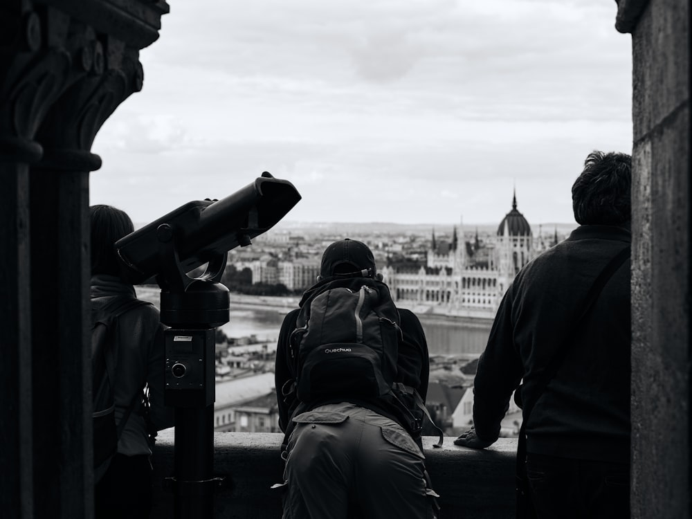 a group of people standing on top of a building