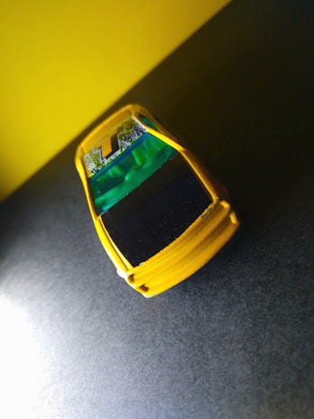 Yellow car with spinning wheels on a dark gray background.