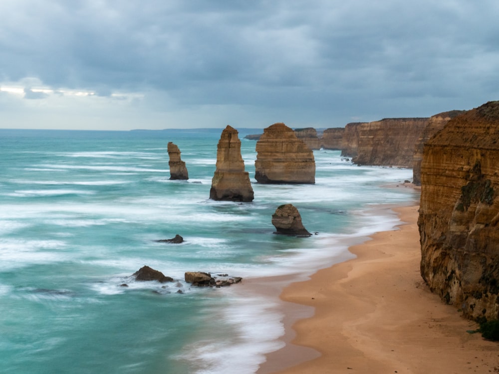 a view of a beach with some rocks in the water