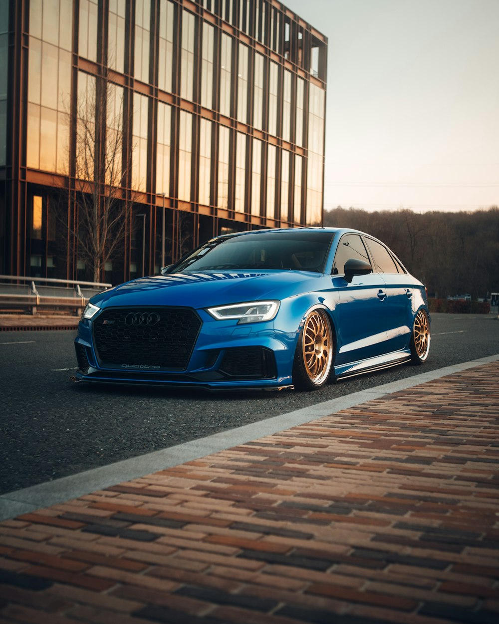 a blue car parked on the side of a road