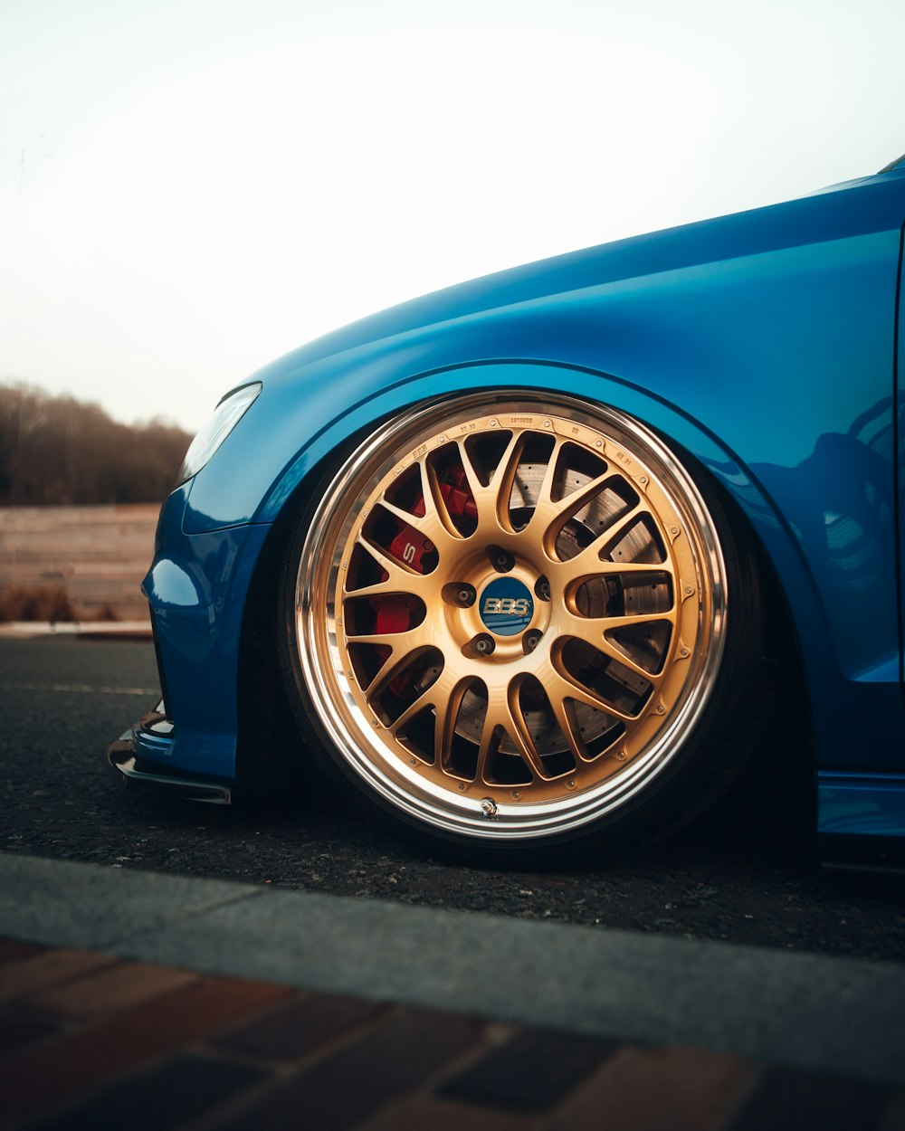 a blue car parked on the side of the road