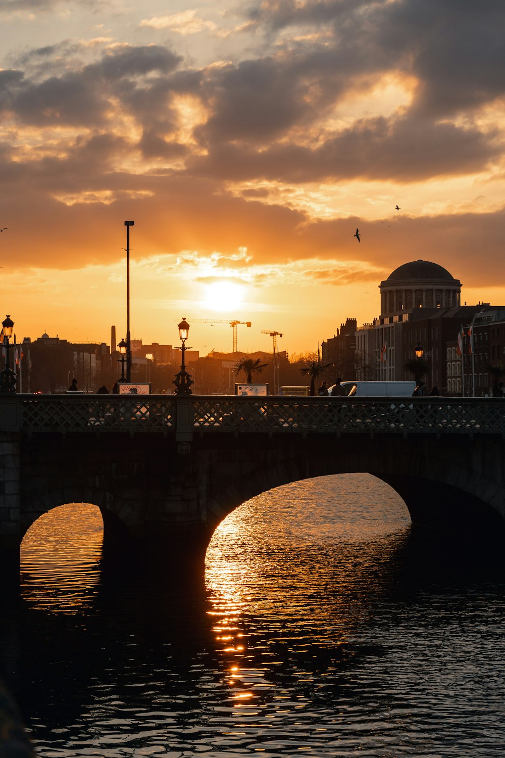 a bridge over a body of water at sunset