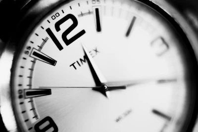 a black and white photo of a clock