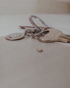 A close-up of a set of keys on a wooden table.