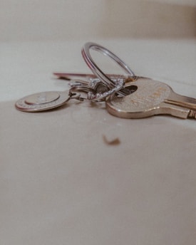 A close-up of various types of keys on a wooden surface.