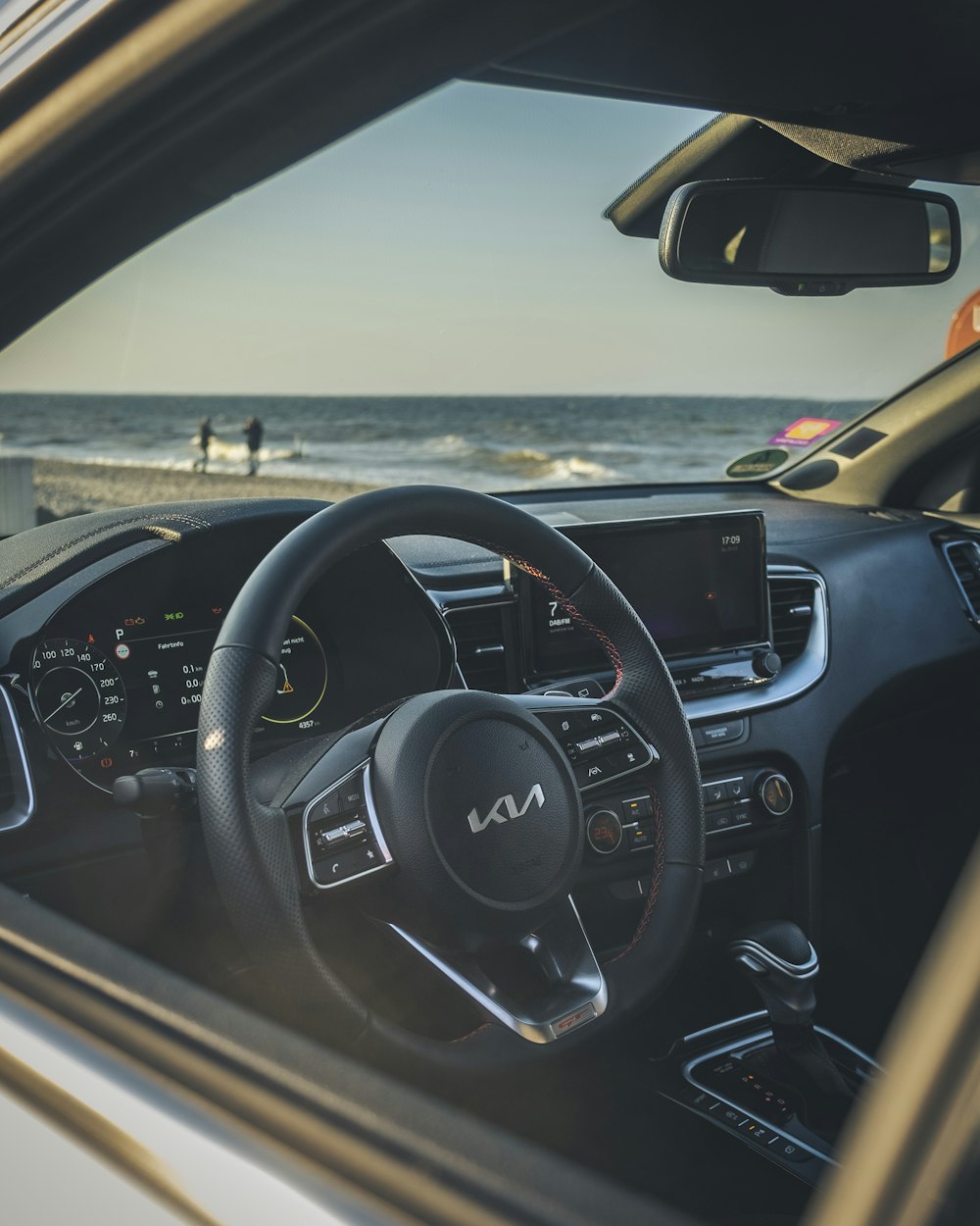 the interior of a car with a view of the beach