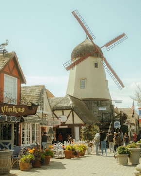 a group of people standing around a windmill