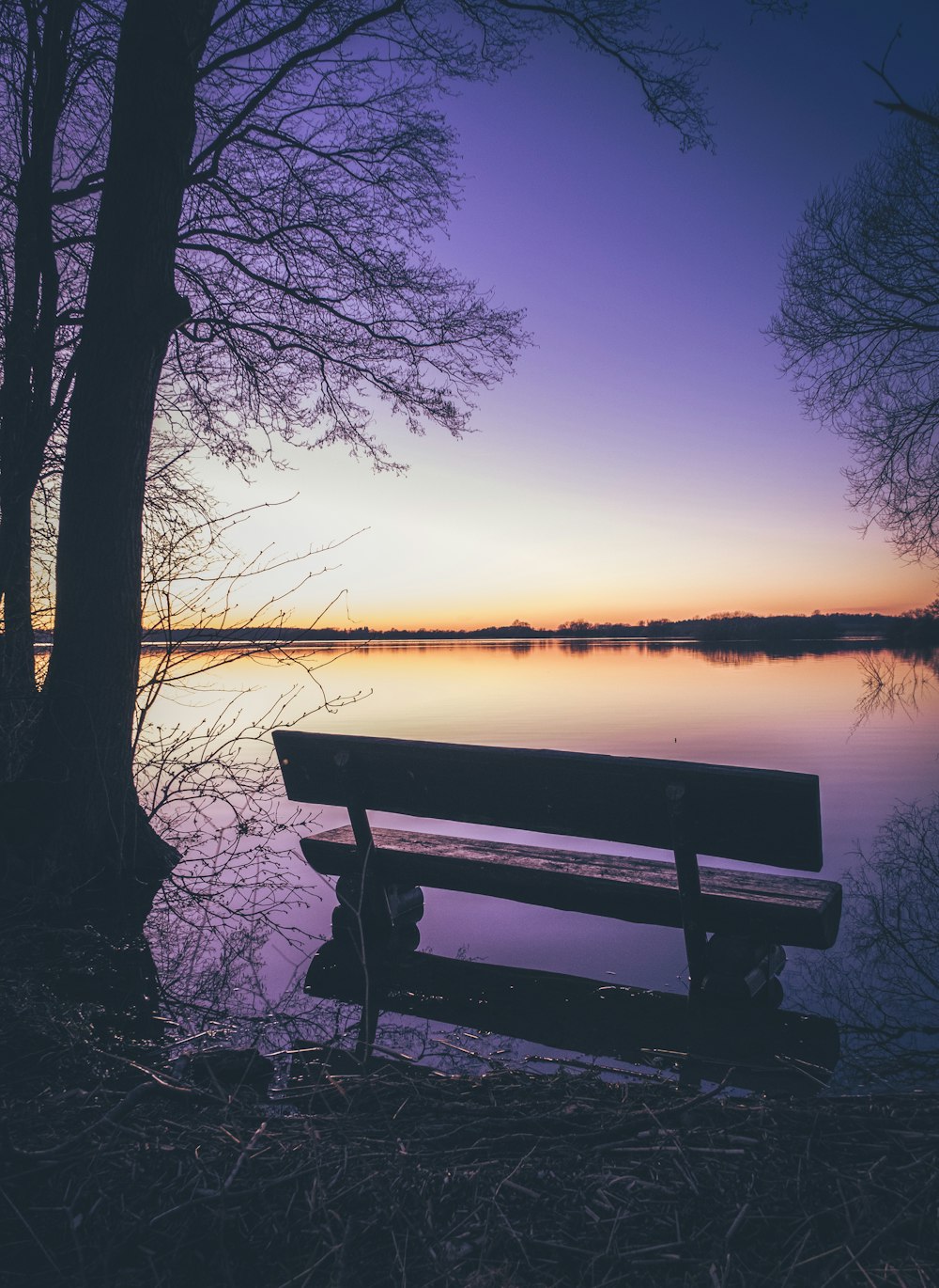 a bench sitting in front of a body of water