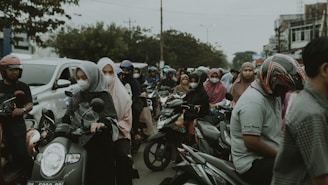 a group of people riding motorcycles down a street