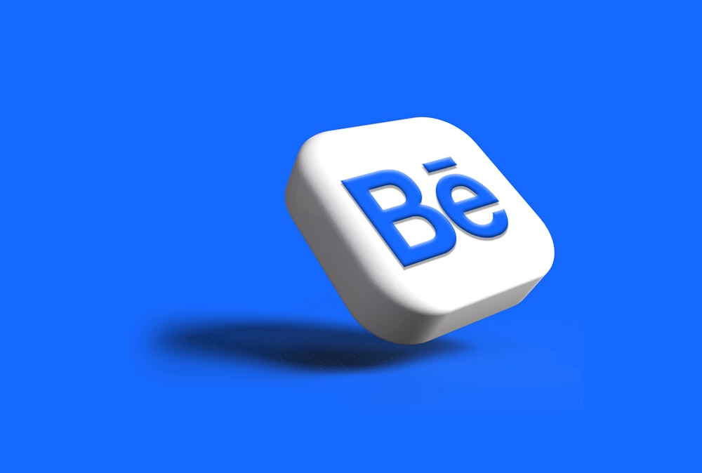 a white dice with the word be on it