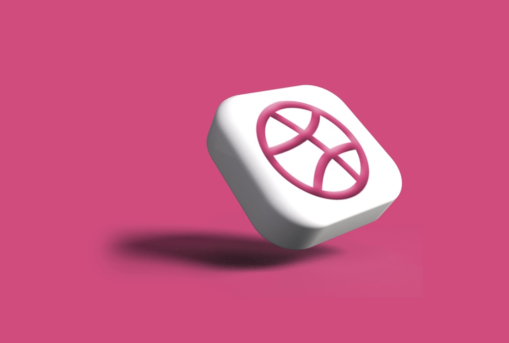 a white and pink object on a pink background