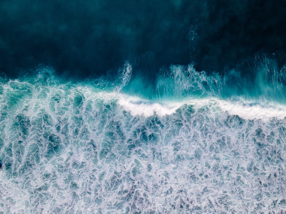 a large body of water with waves coming in and out of it