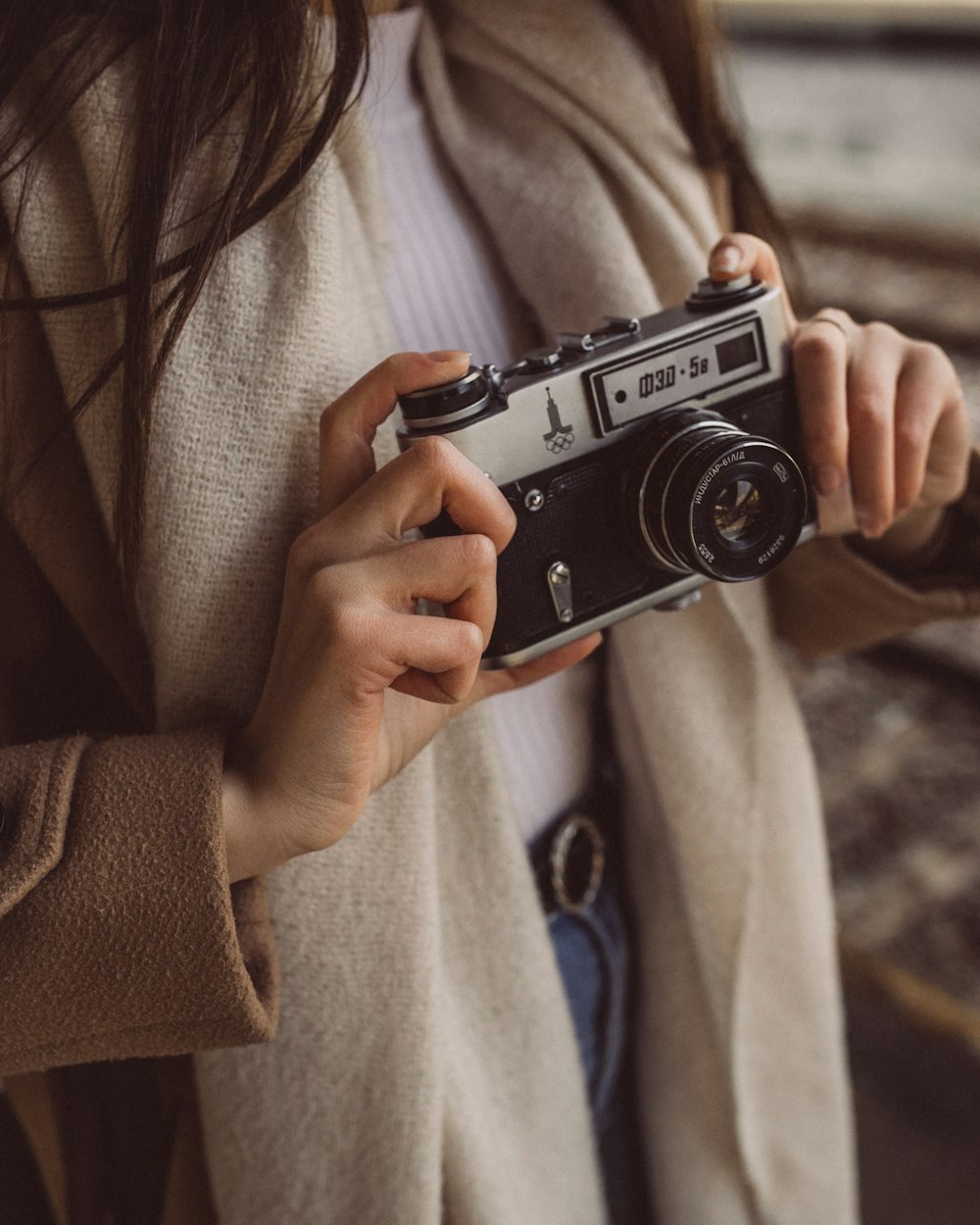 a woman holding a camera in her hands