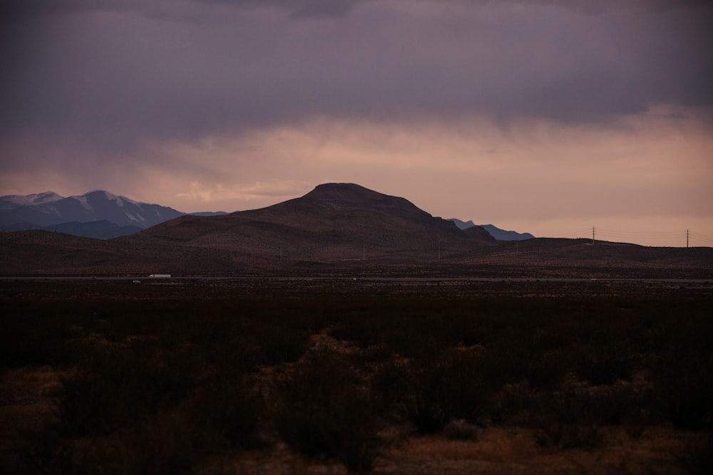 a mountain range with a few clouds in the sky