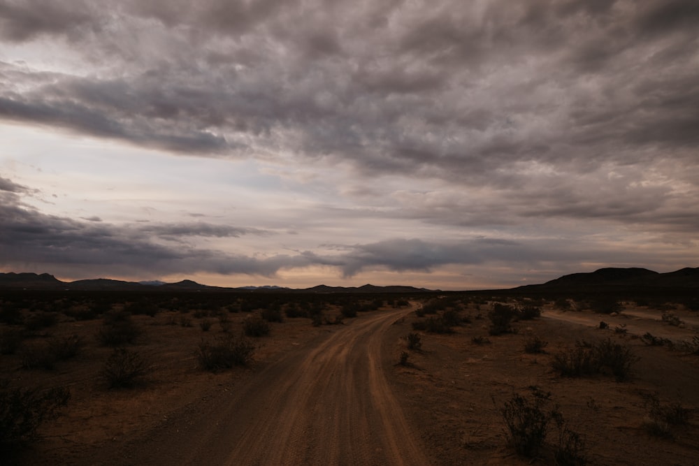 a dirt road in the middle of a desert