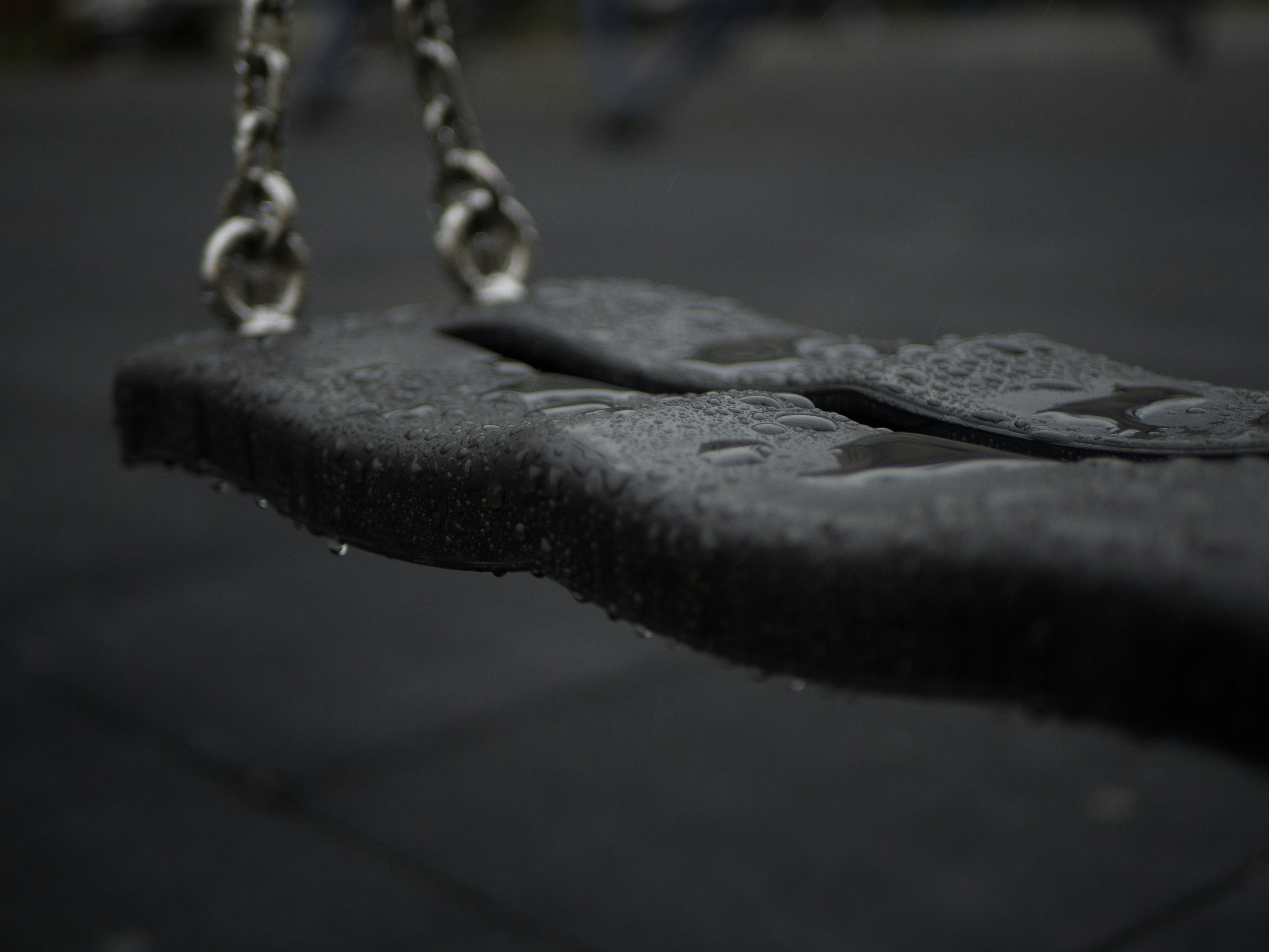 a black and white photo of a swing