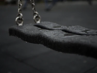 a black and white photo of a swing