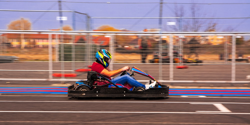 a person riding a go kart in a parking lot