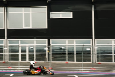 a person riding a go kart in a parking lot