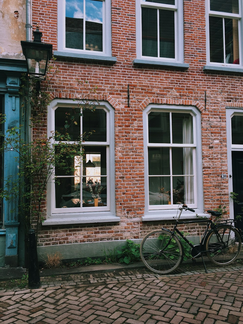 a bicycle parked in front of a brick building