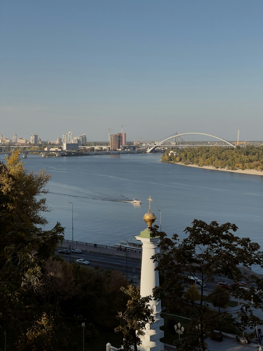 a large body of water with a bridge in the background