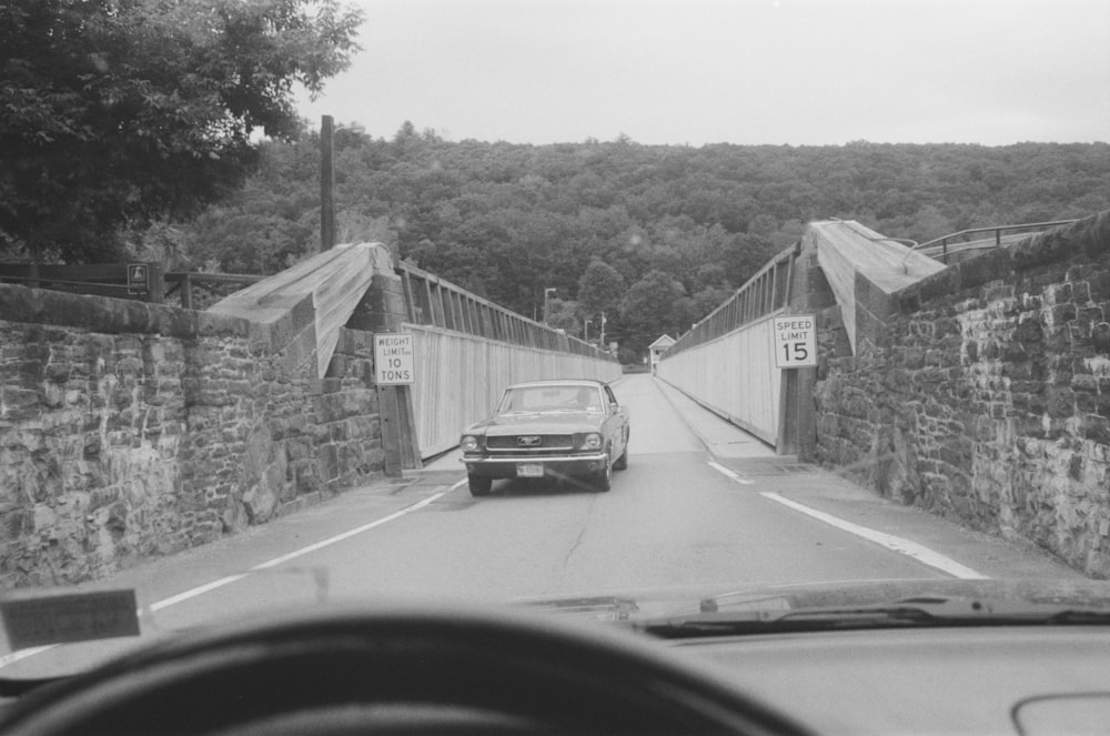 a car driving over a bridge on a road