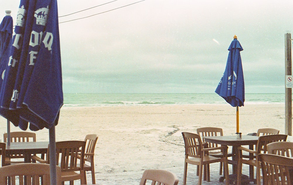 tables and chairs are set up on the beach