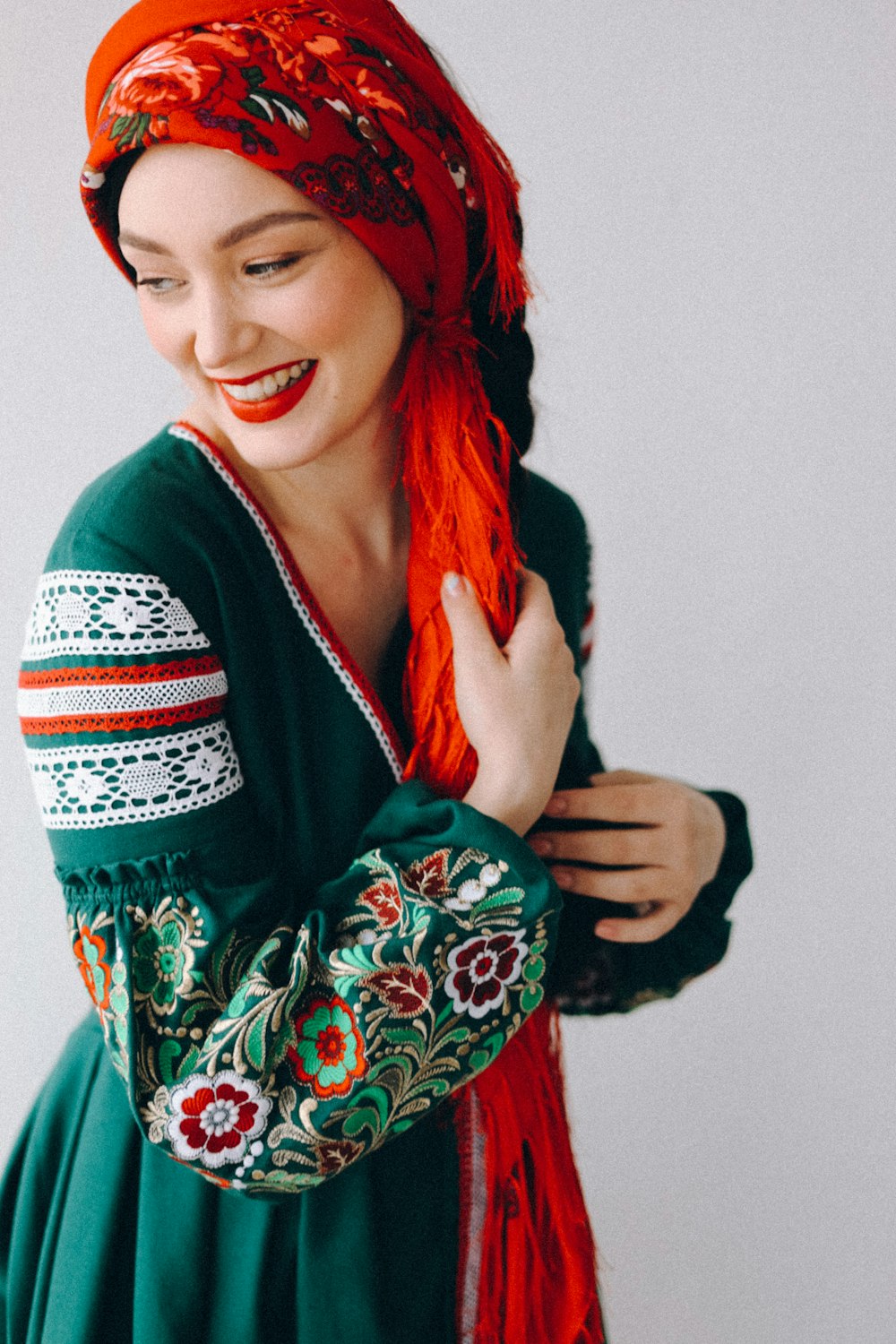 a woman with red hair wearing a green dress