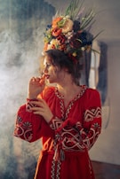 a woman in a red dress smoking a cigarette