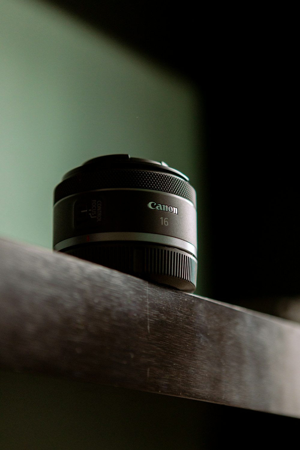 a camera lens sitting on top of a wooden shelf