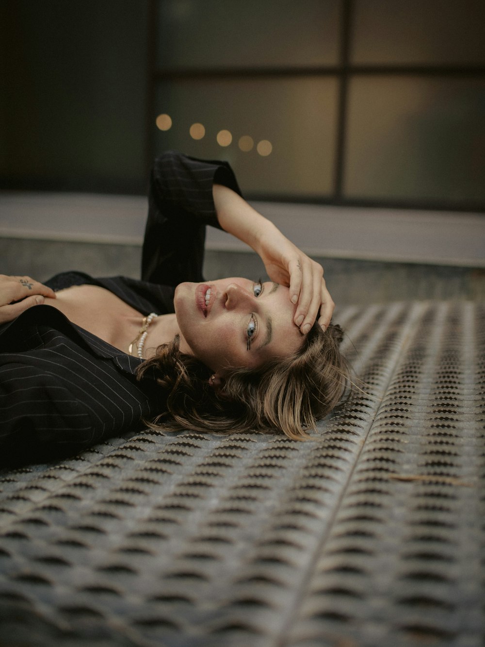 a woman laying on the ground in a black dress