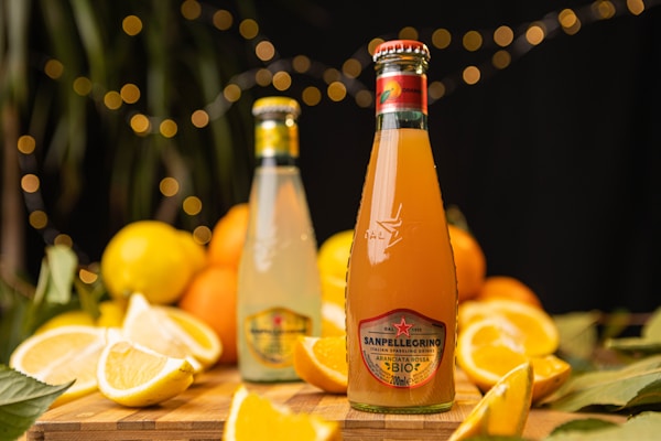 A bottle of orange juice sitting on top of a wooden table