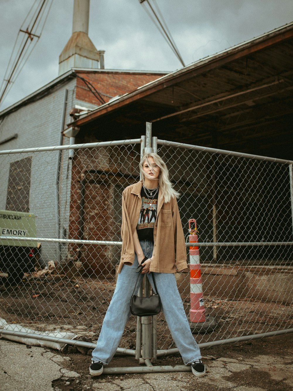 a woman standing on top of a metal pole