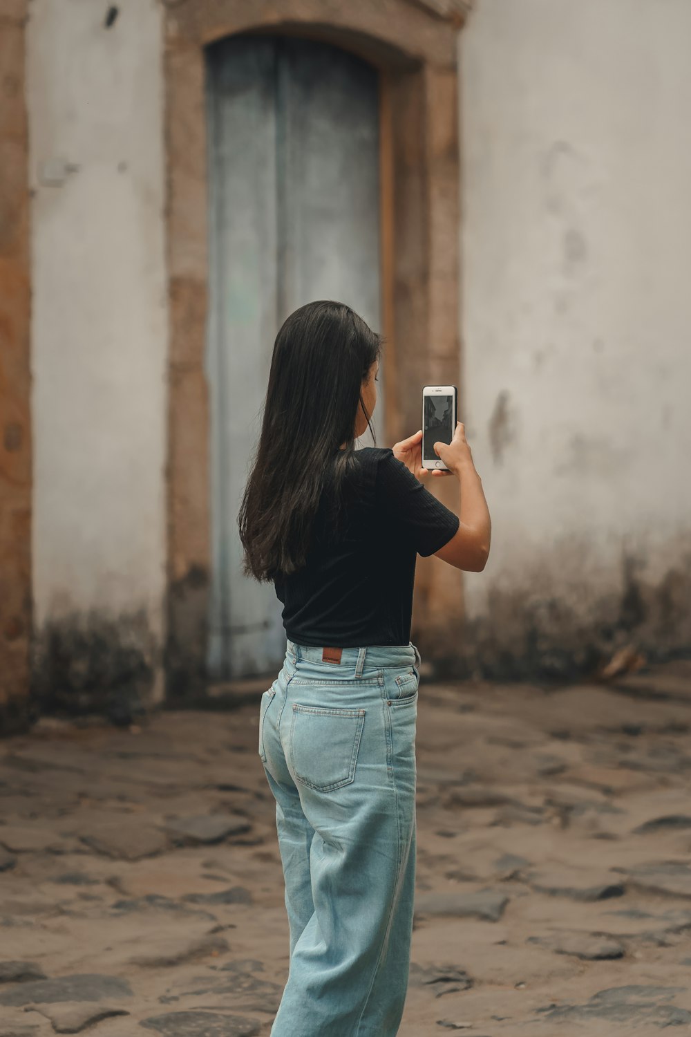 a woman taking a picture with her cell phone