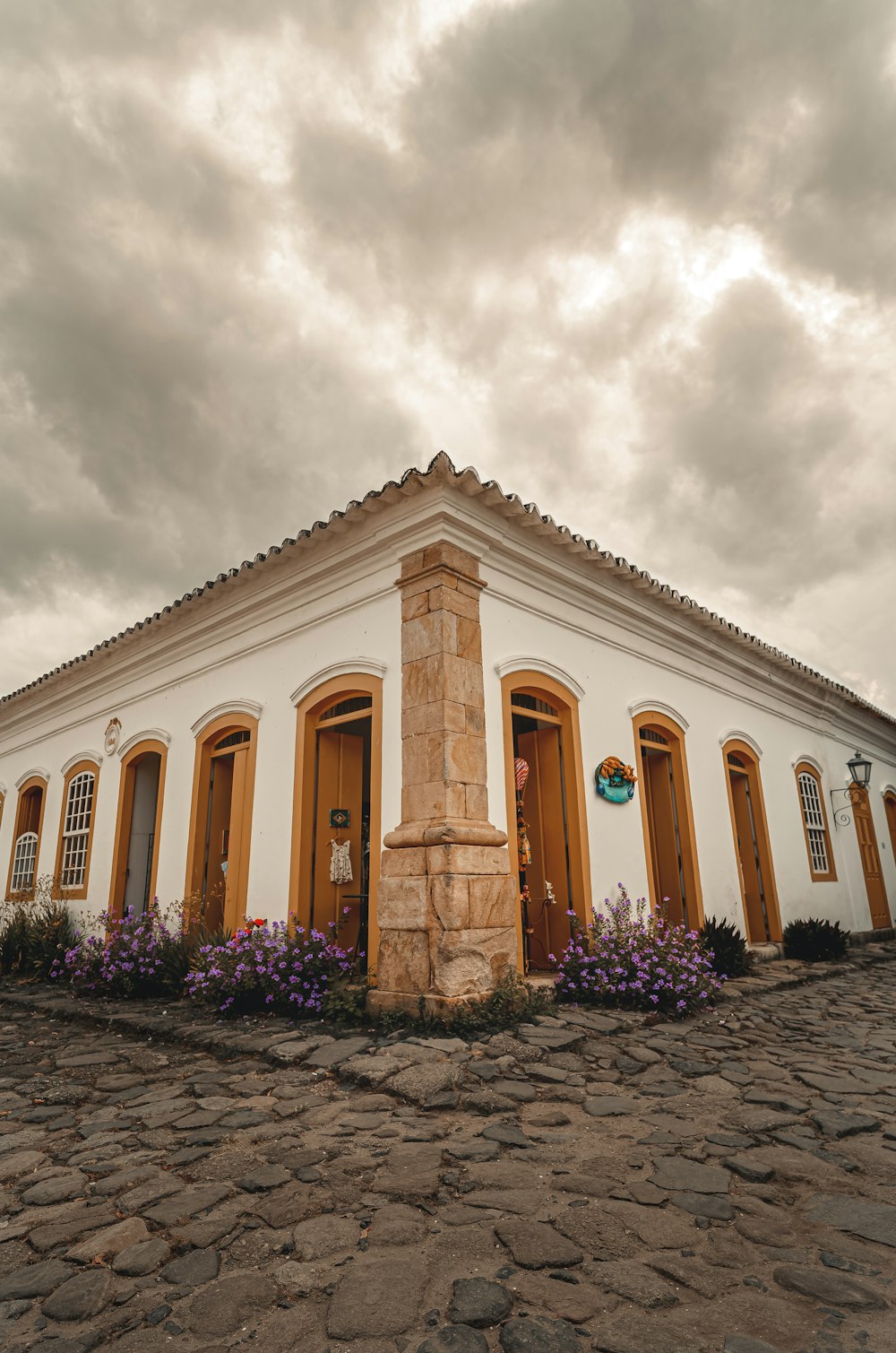 a white building with yellow doors and windows