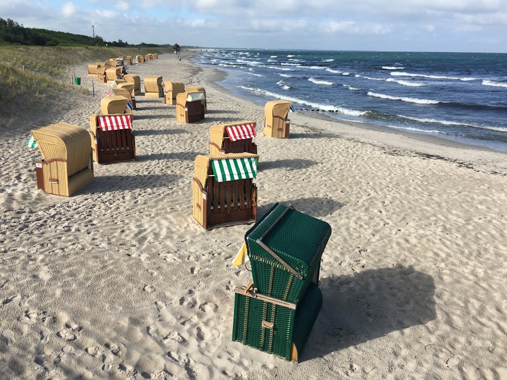a row of beach chairs sitting on top of a sandy beach