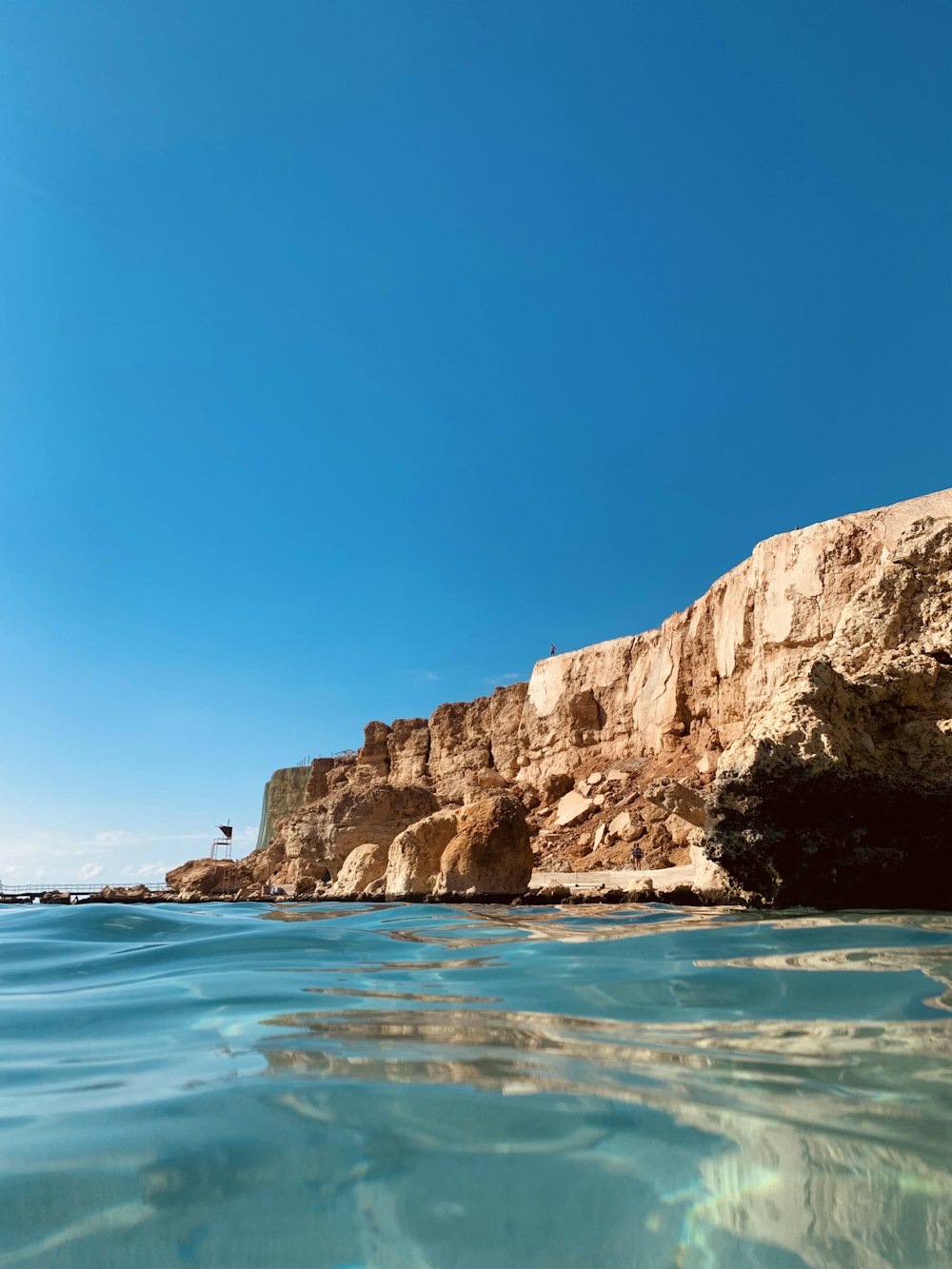 the water is crystal blue and the rocks are brown